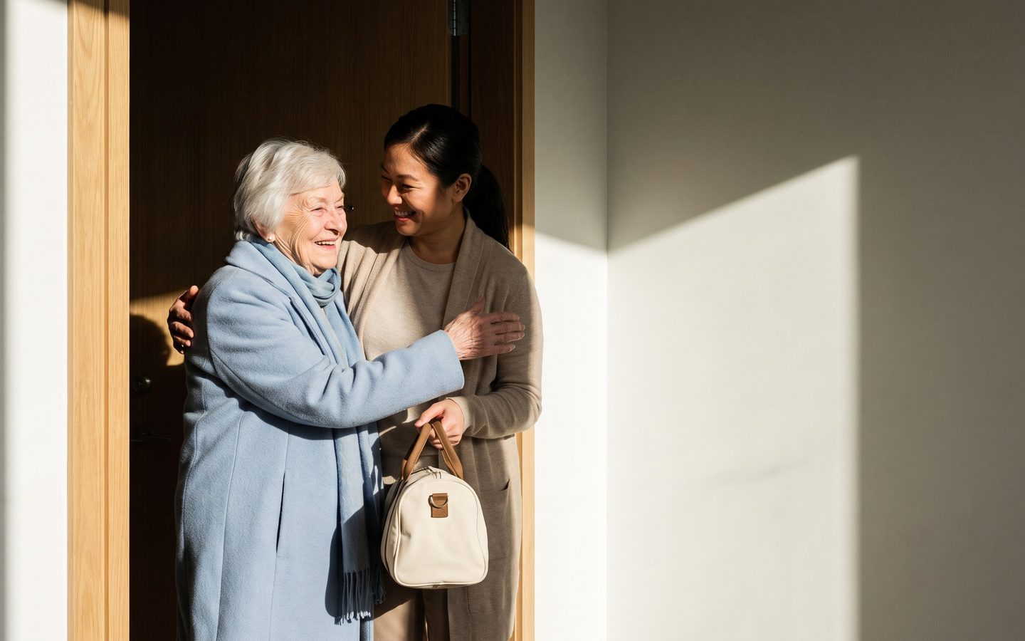 An older woman being welcomed back through her own front door